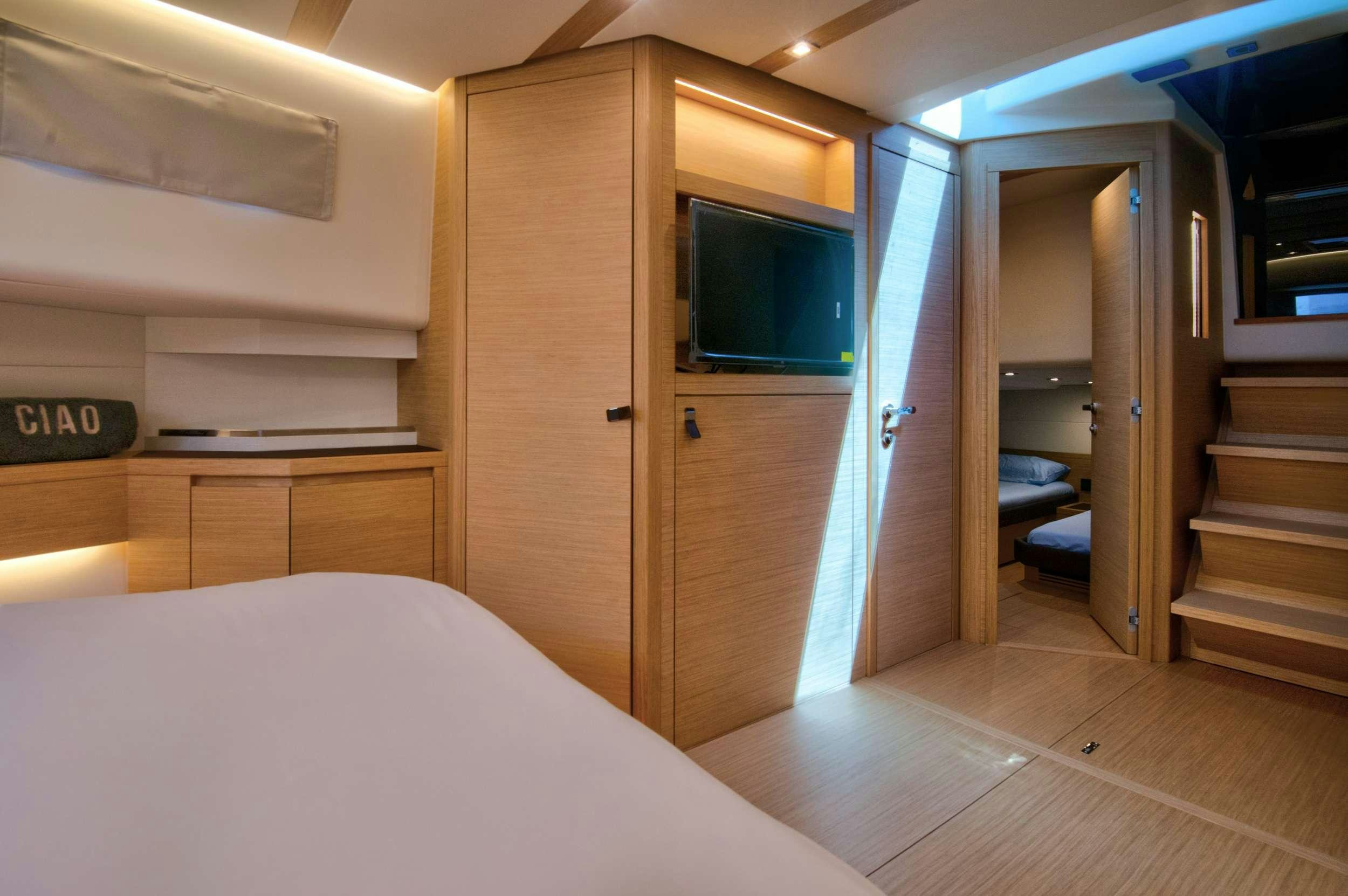 a room with a bed and a closet aboard PARDO 50 Yacht for Charter