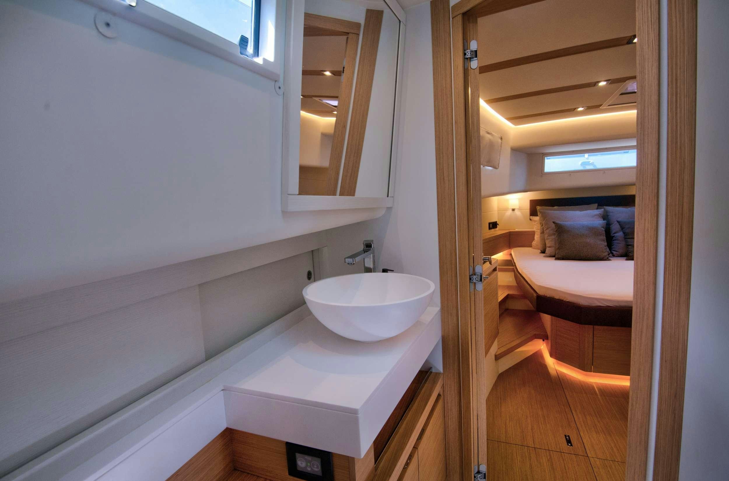 a bathroom with a sink and a bed aboard PARDO 50 Yacht for Charter