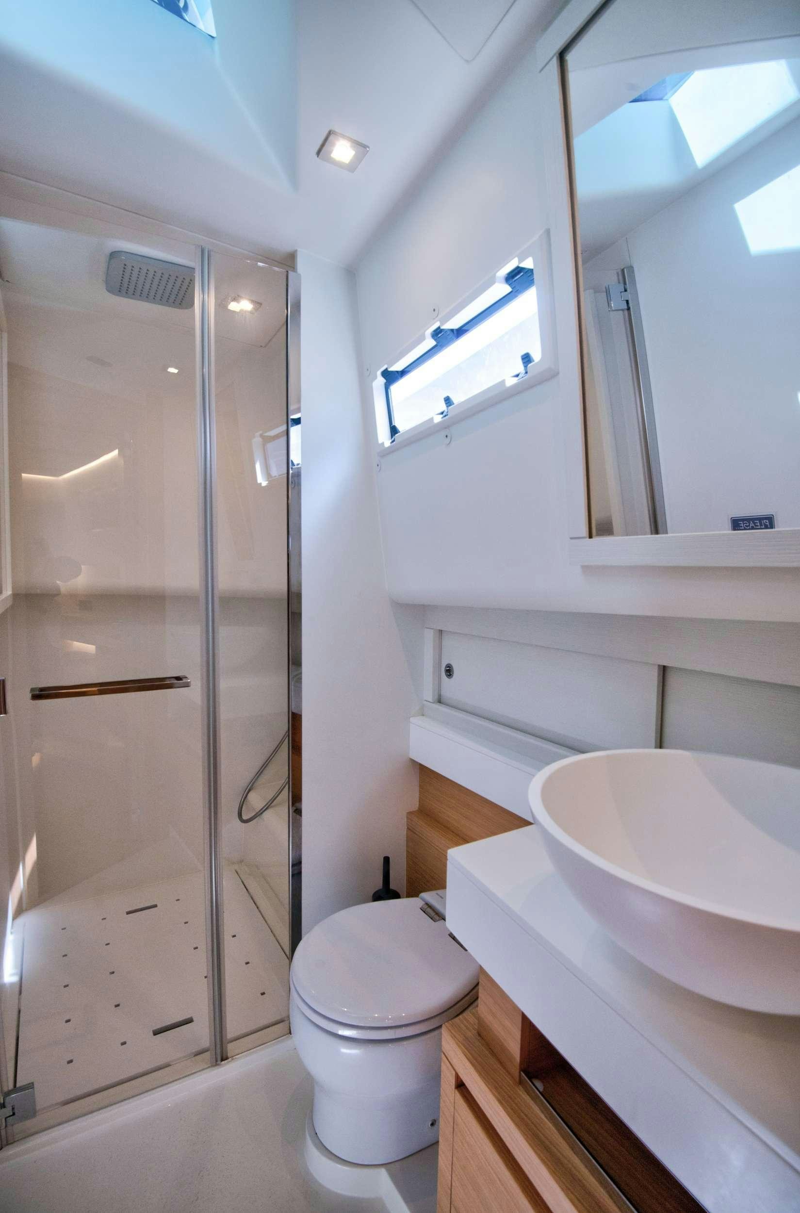 a bathroom with a glass shower aboard PARDO 50 Yacht for Charter
