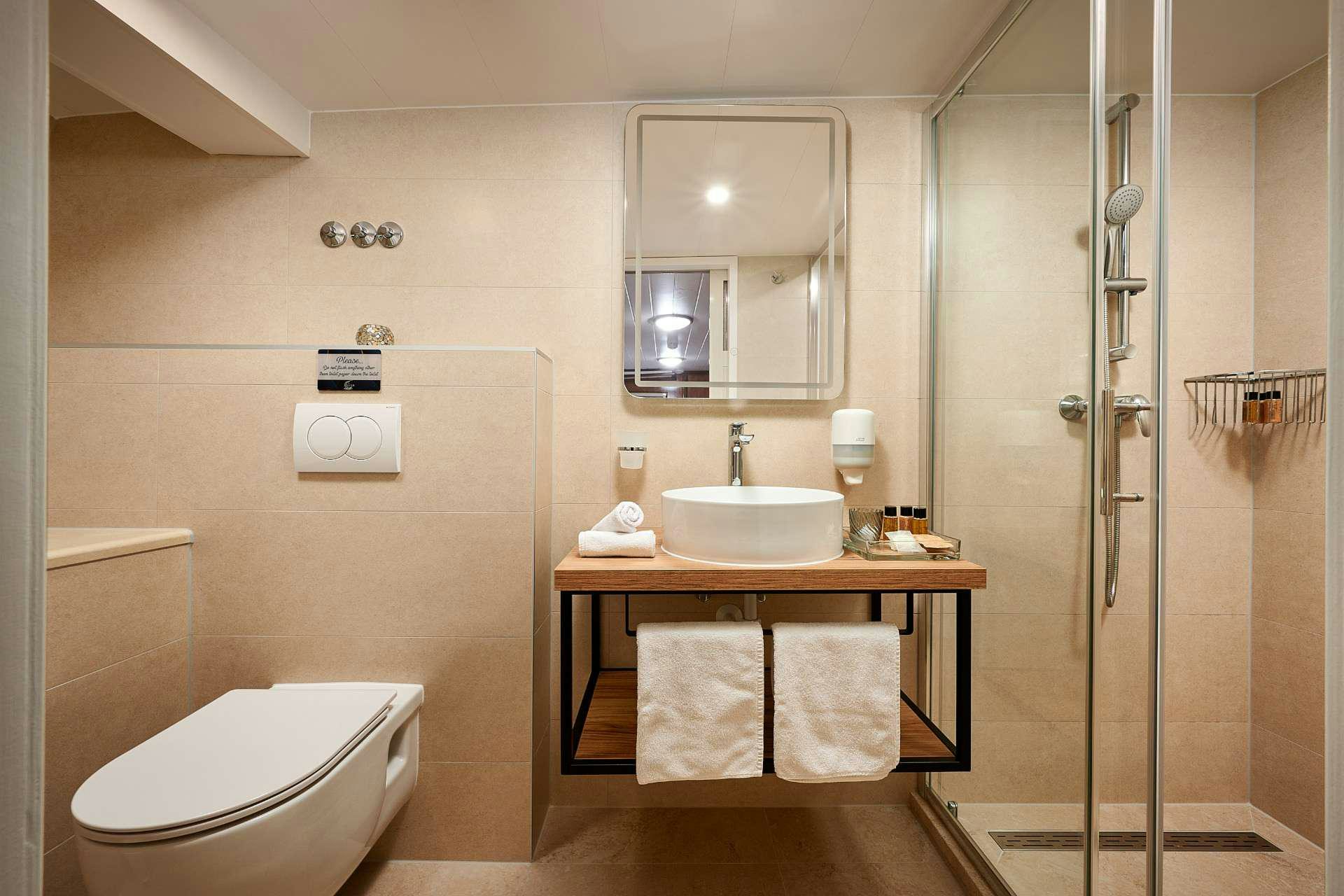 a bathroom with a sink and a toilet aboard LUNA Yacht for Charter
