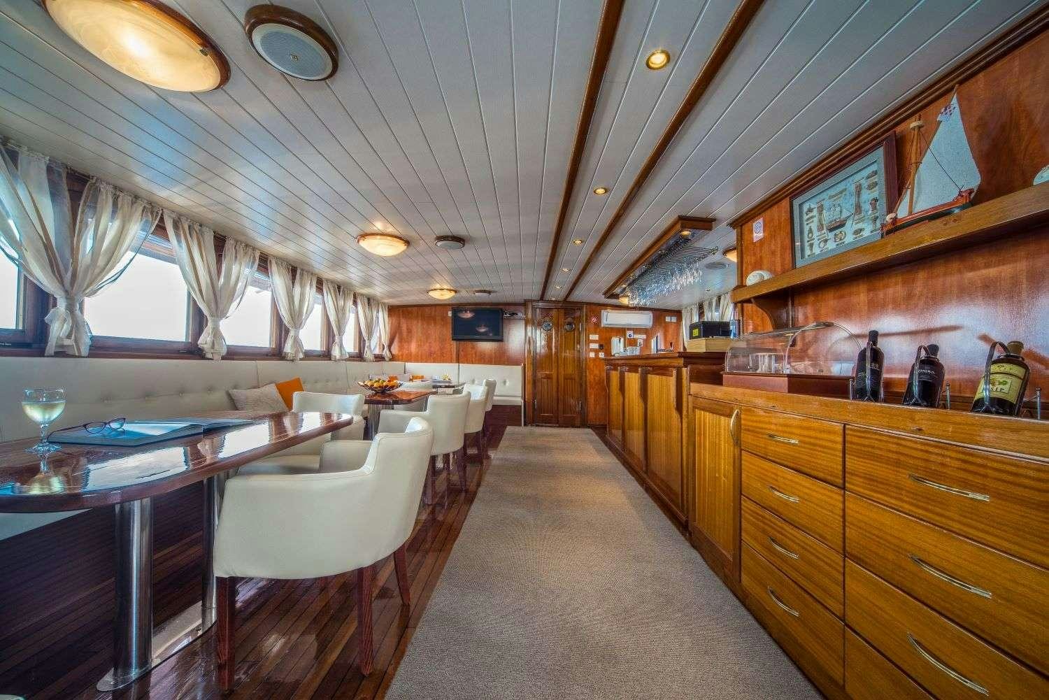a large room with a large table and chairs aboard LUNA Yacht for Charter