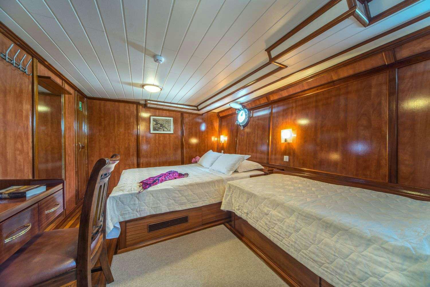 a room with two beds aboard LUNA Yacht for Charter