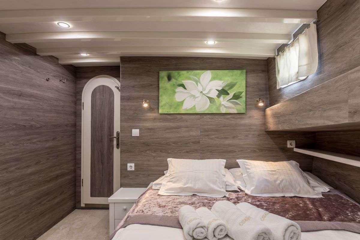 a bed in a cabin aboard ANDEO Yacht for Charter