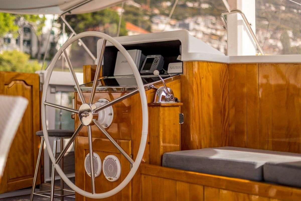 a wooden model of a ship aboard ANDEO Yacht for Charter