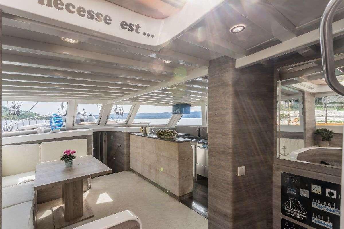 a room with a table and chairs aboard ANDEO Yacht for Charter