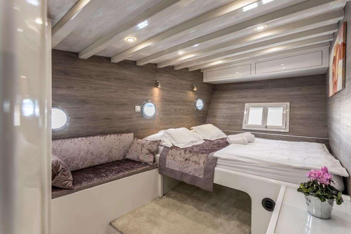 a room with two beds aboard ANDEO Yacht for Charter