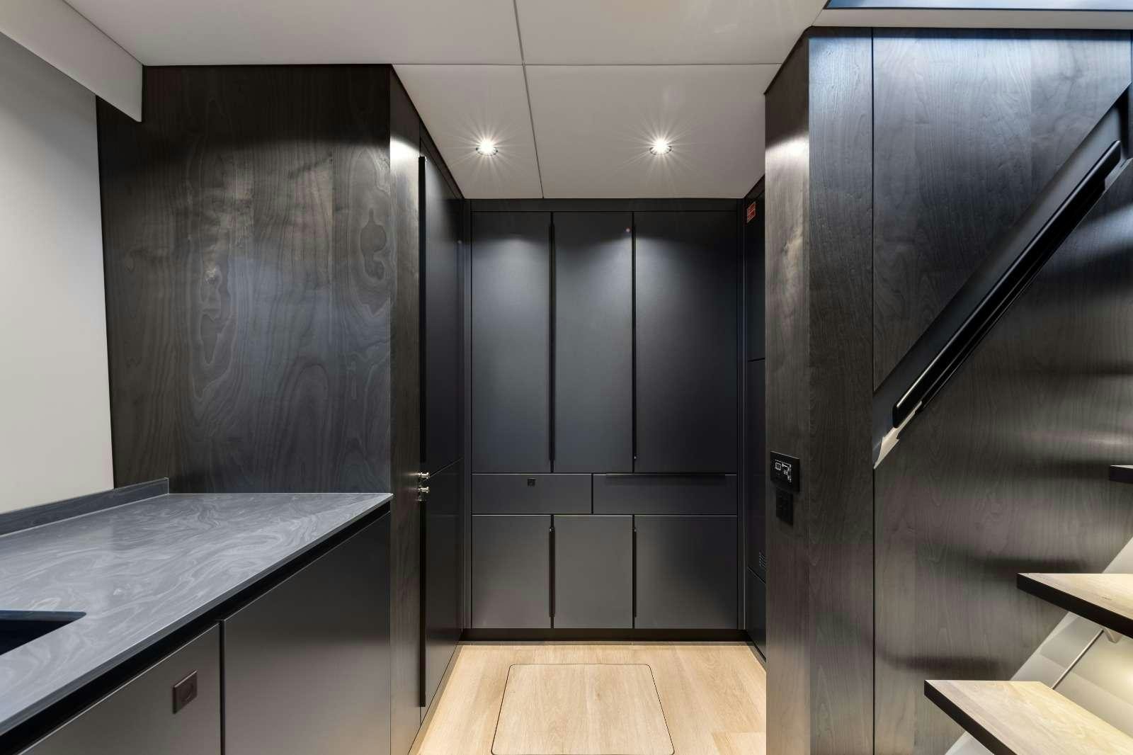 a room with black cabinets aboard AGATA BLU Yacht for Charter