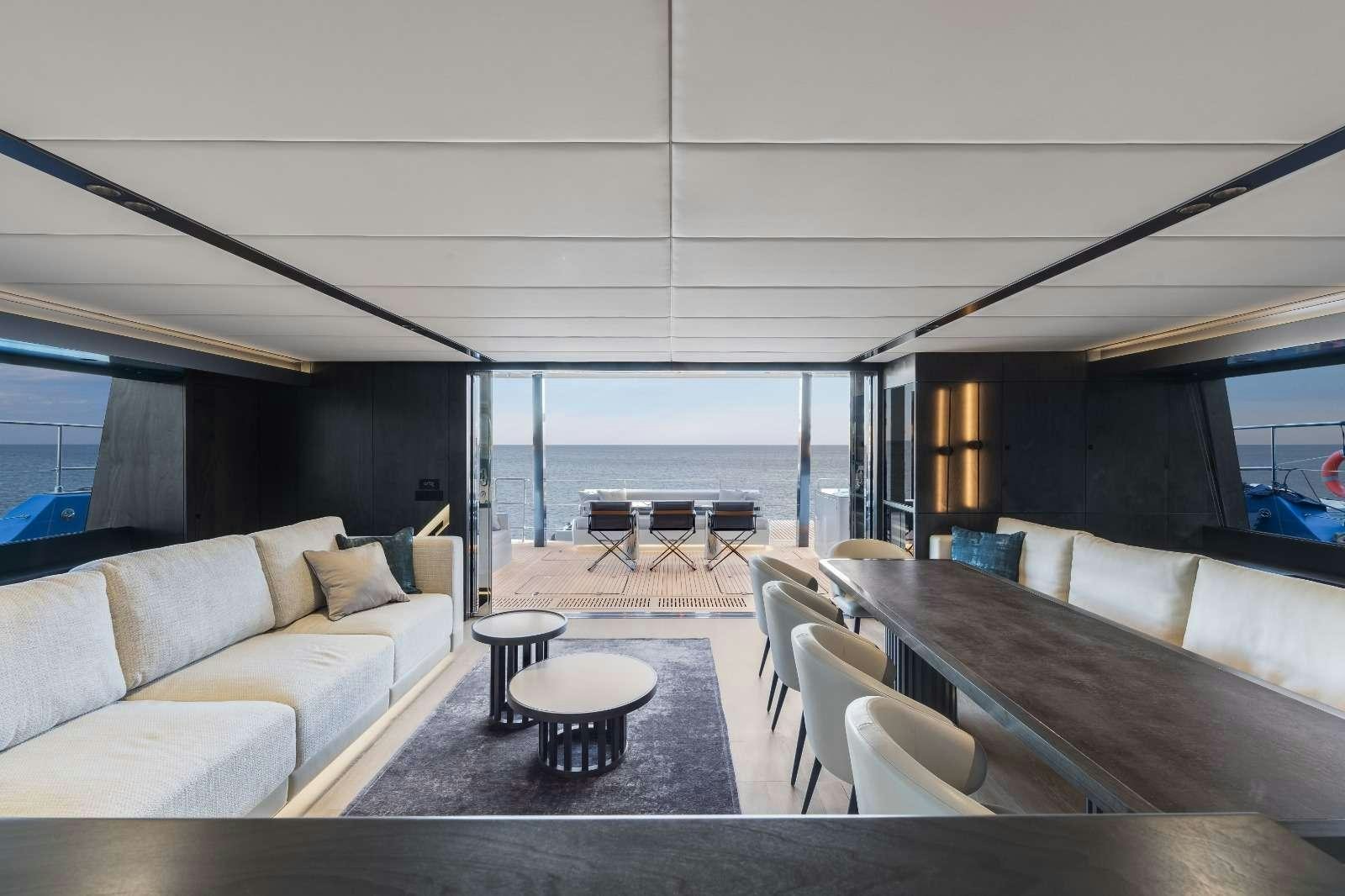 a living room with a large window aboard AGATA BLU Yacht for Charter