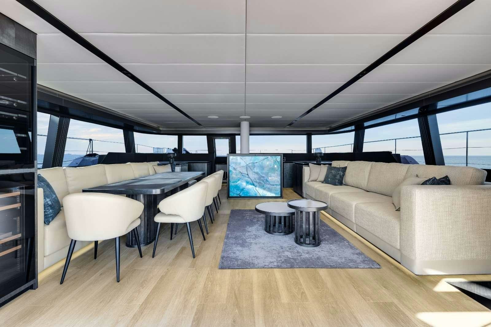 a living room with a couch and a table aboard AGATA BLU Yacht for Charter