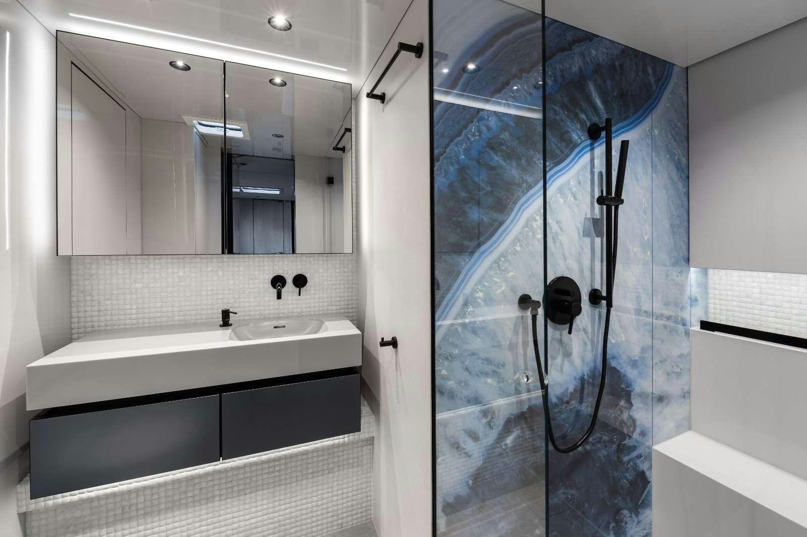 a bathroom with a glass shower aboard AGATA BLU Yacht for Charter