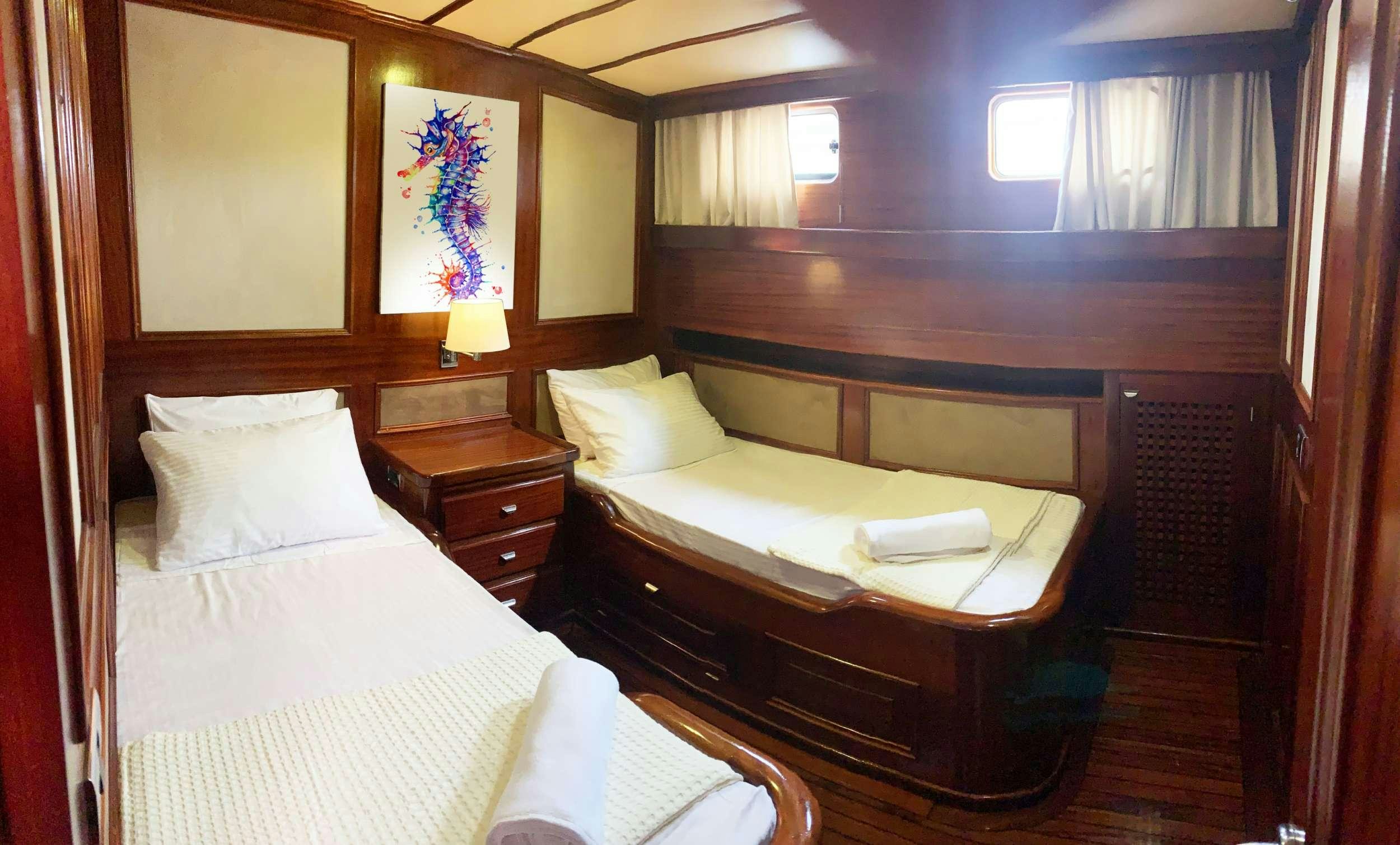 a room with two beds aboard ELIANORA Yacht for Charter