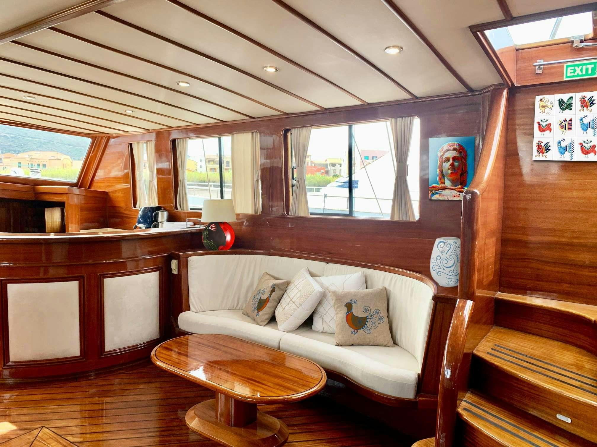a room with a couch and a coffee table aboard ELIANORA Yacht for Charter