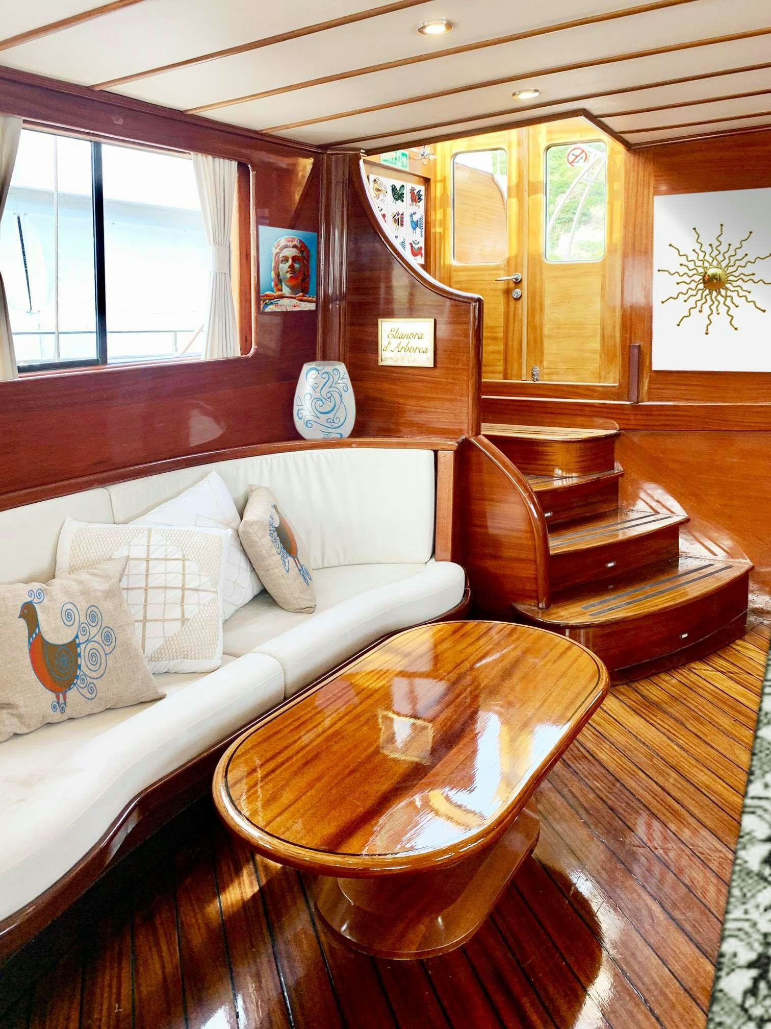 a room with a bed and a chair aboard ELIANORA Yacht for Charter