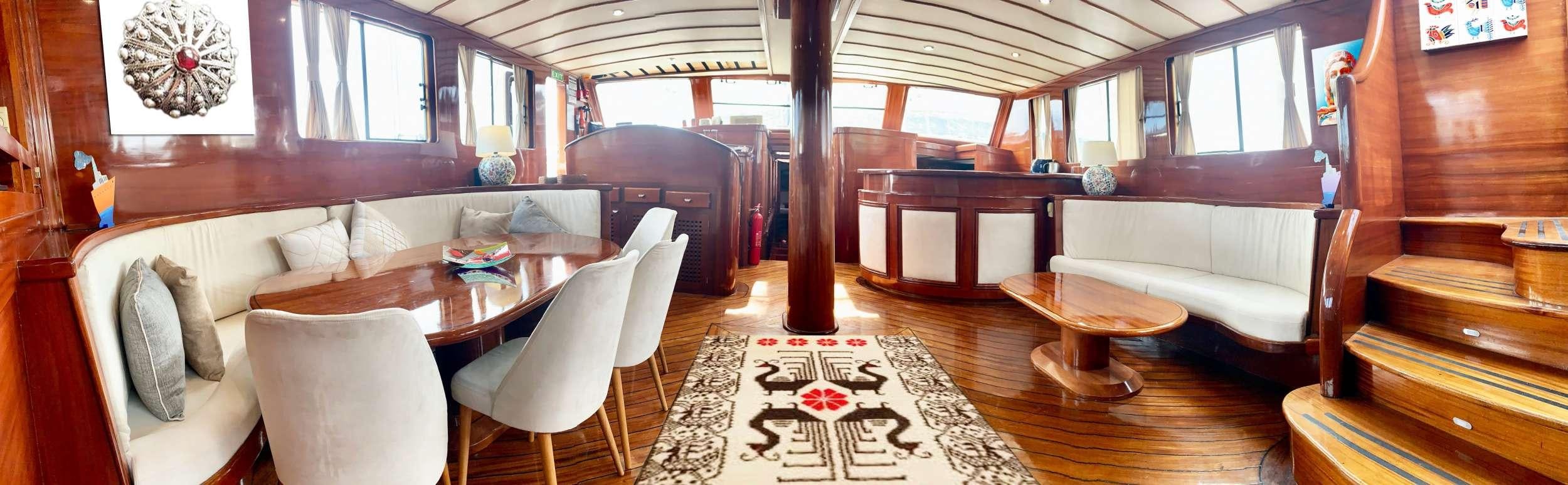 a living room with a couch and a table aboard ELIANORA Yacht for Charter