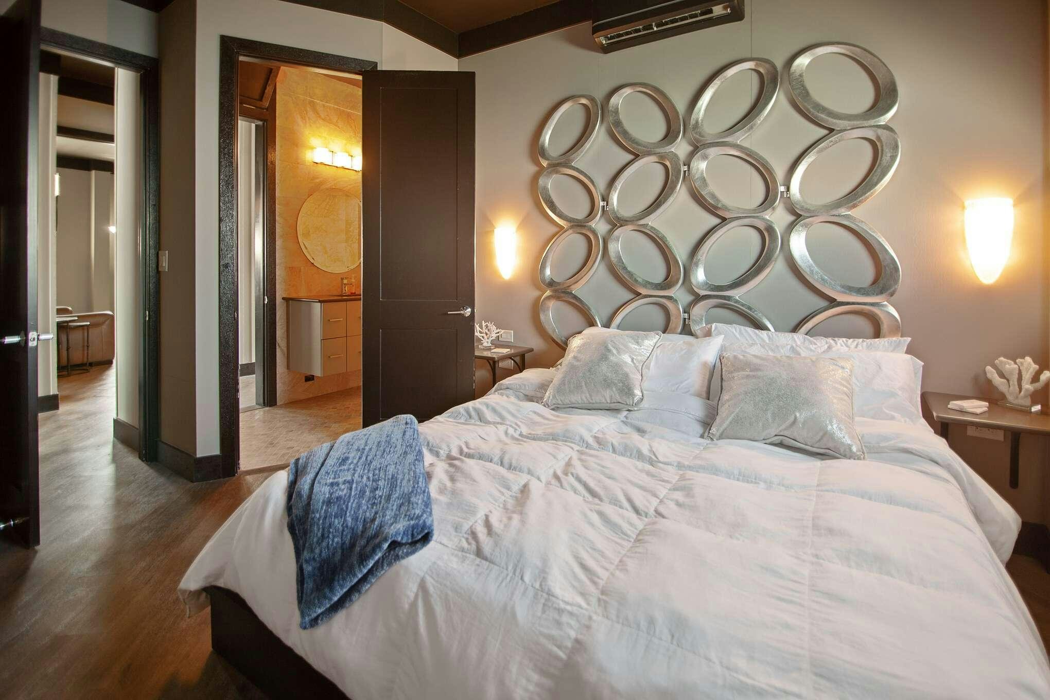 a bed with a white sheet and pillows in a hotel room aboard MANSION YACHT Yacht for Charter