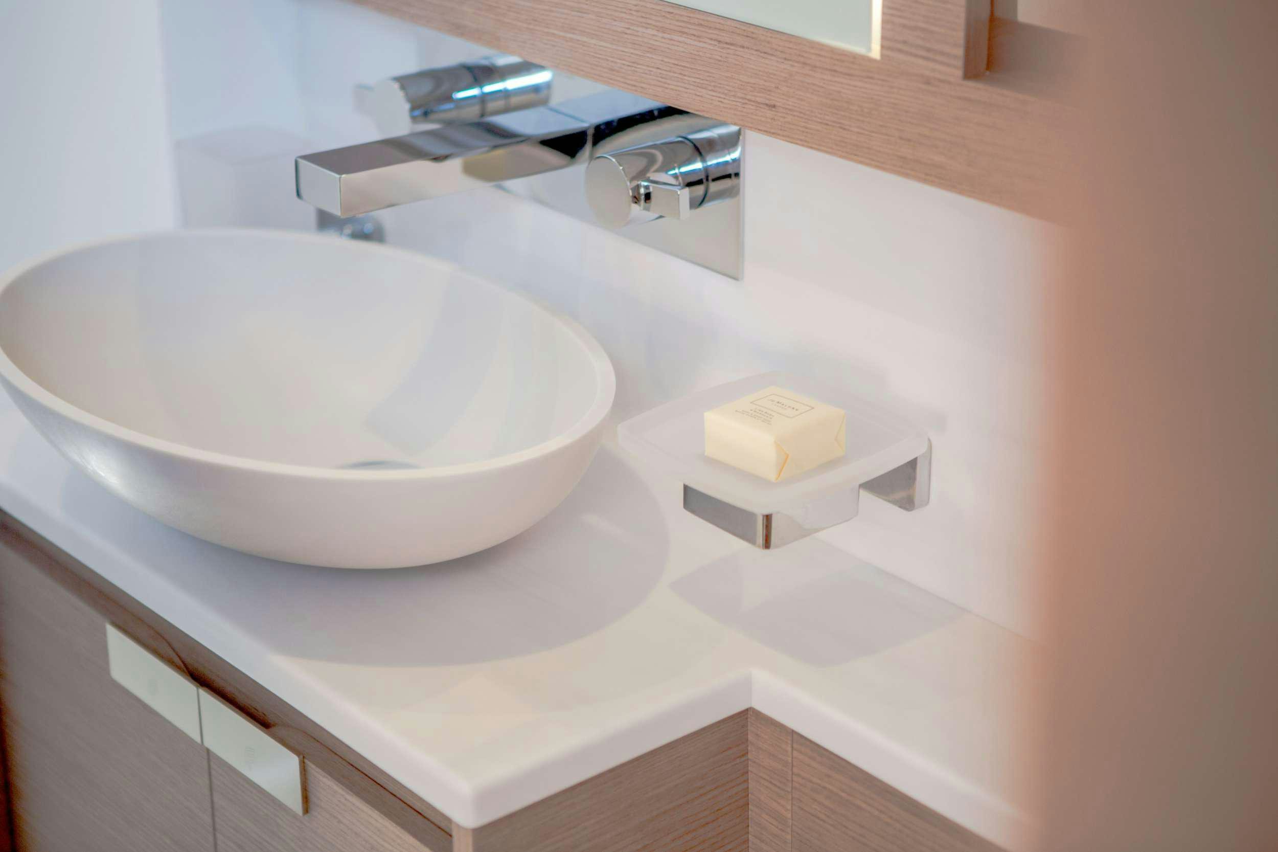 a white bathtub with a square sink aboard ALENA Yacht for Charter