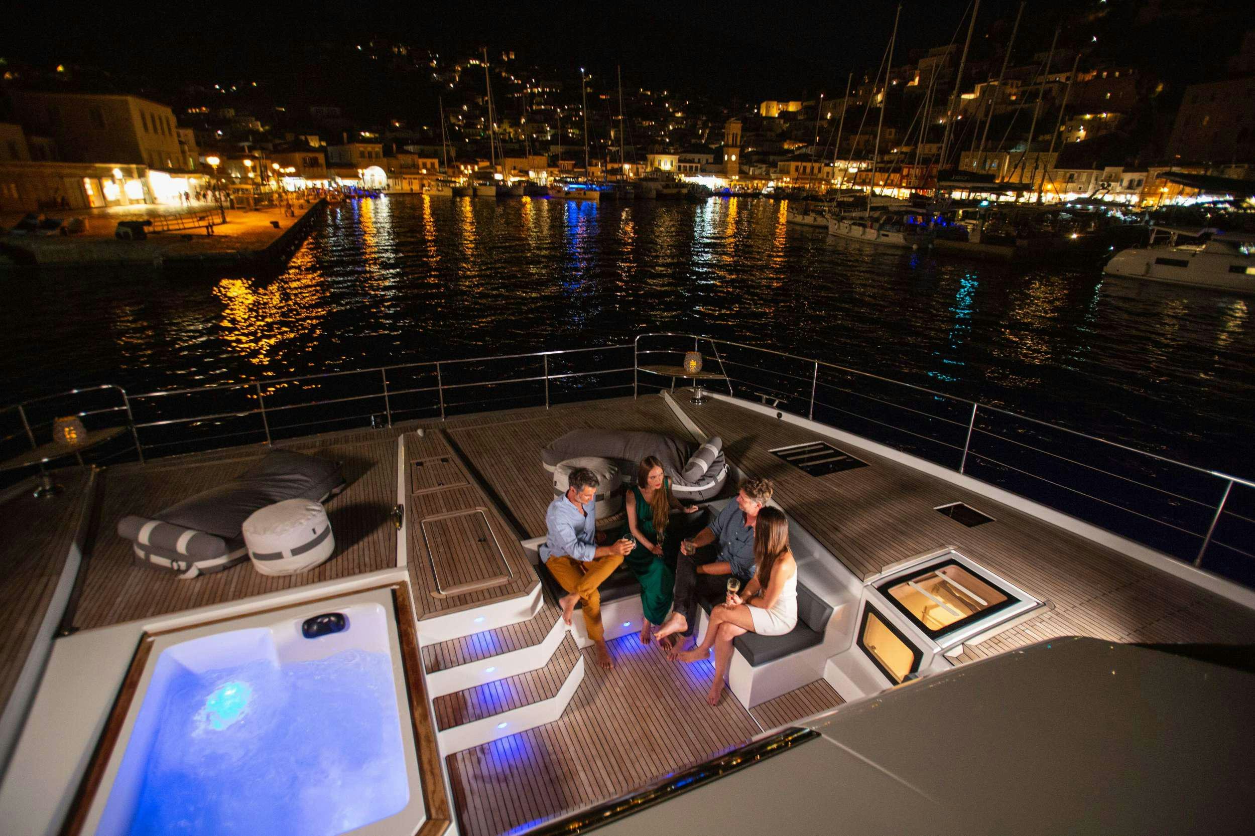 people on a boat at night aboard ALENA Yacht for Charter