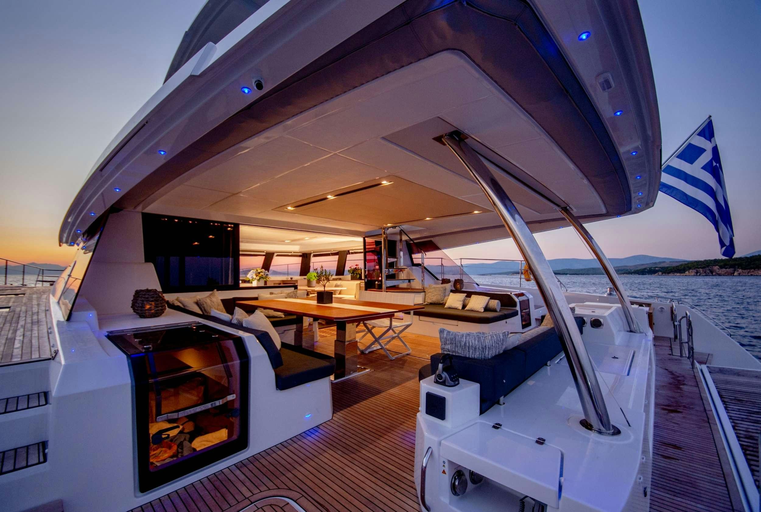 a deck with a table and chairs aboard ALENA Yacht for Charter