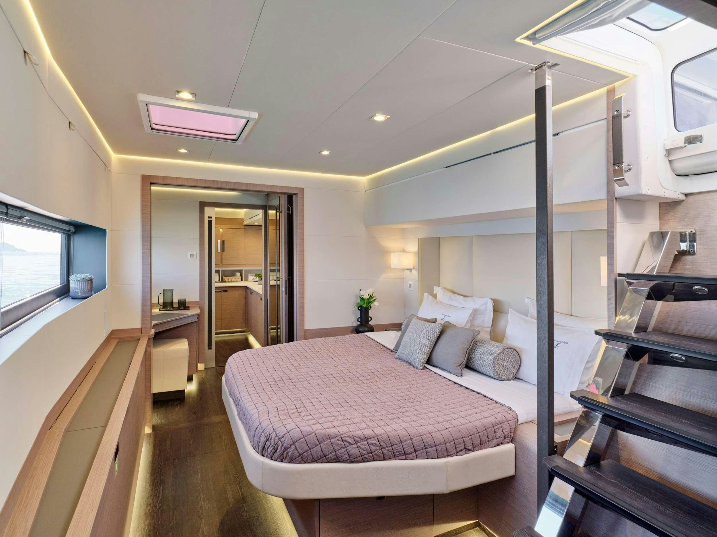a bedroom with a bed and a desk aboard ALENA Yacht for Charter
