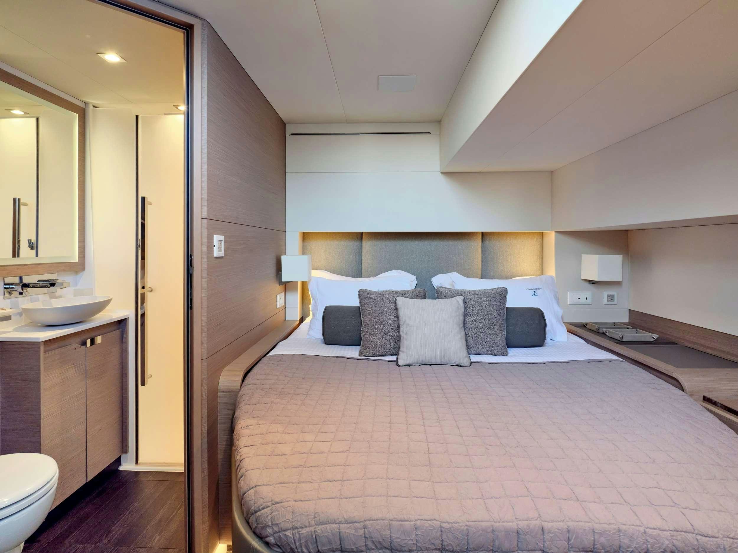 a bed with a white bed spread aboard ALENA Yacht for Charter