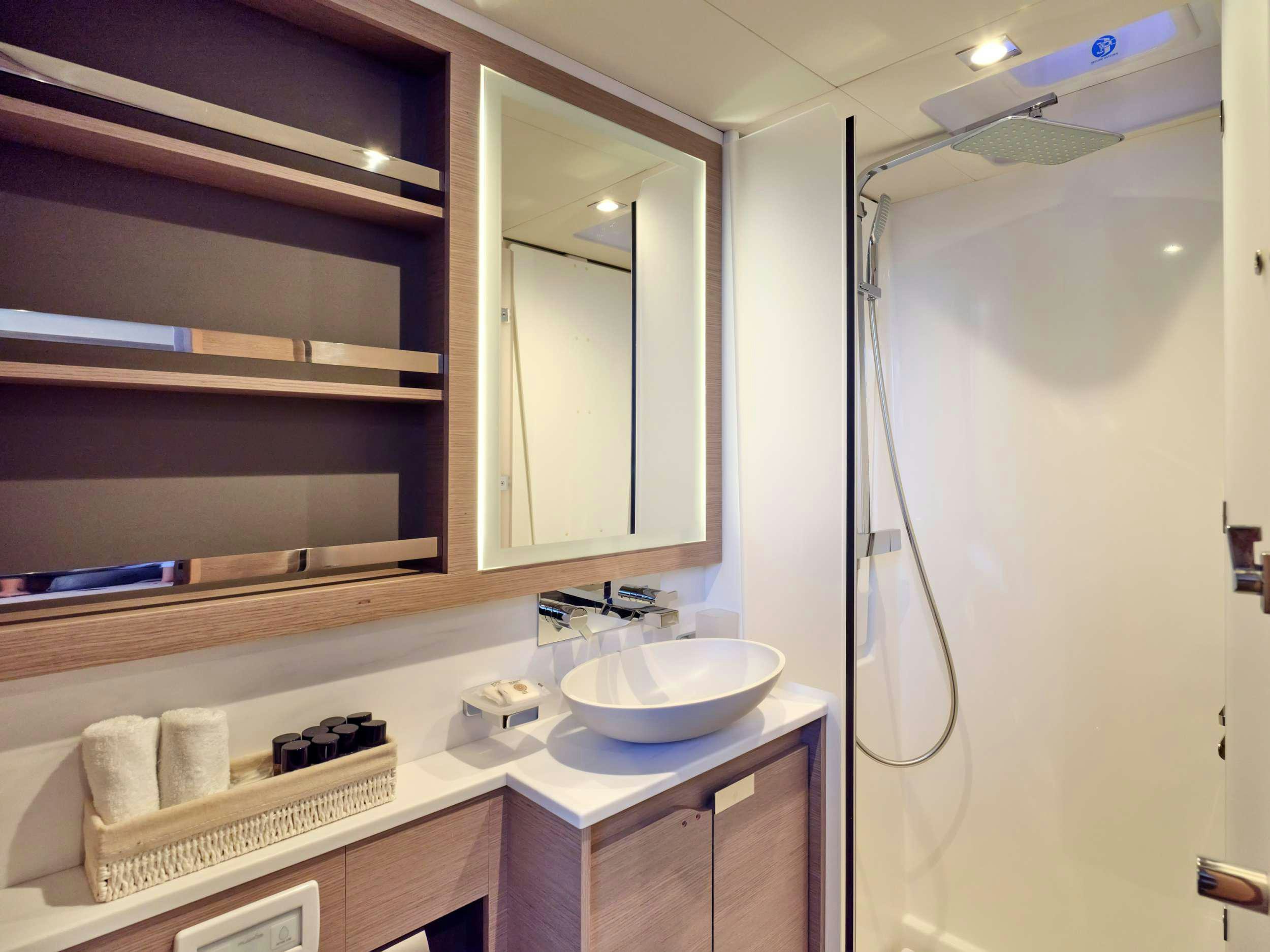 a bathroom with a sink and a mirror aboard ALENA Yacht for Charter