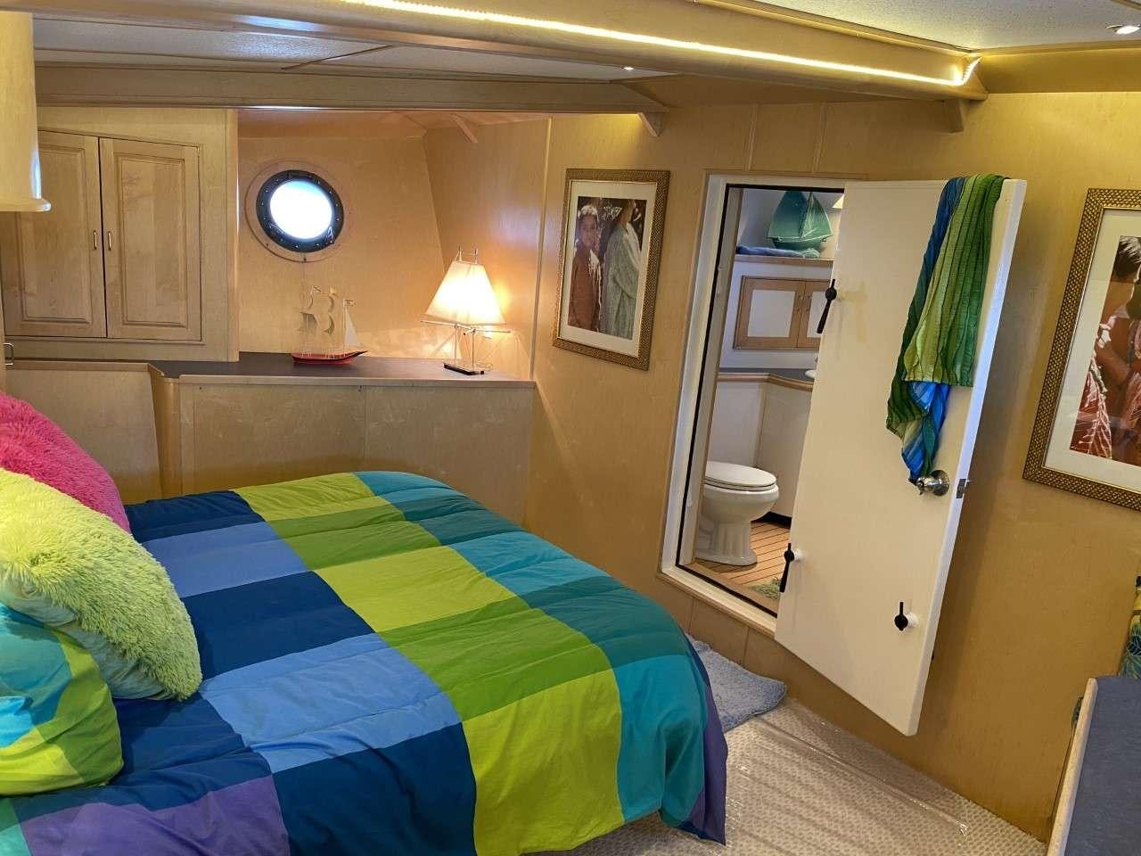 a bedroom with a bed and a door aboard BEAR PAW Yacht for Charter