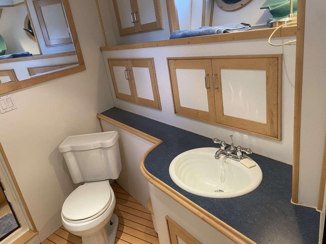 a bathroom with a sink and toilet aboard BEAR PAW Yacht for Charter