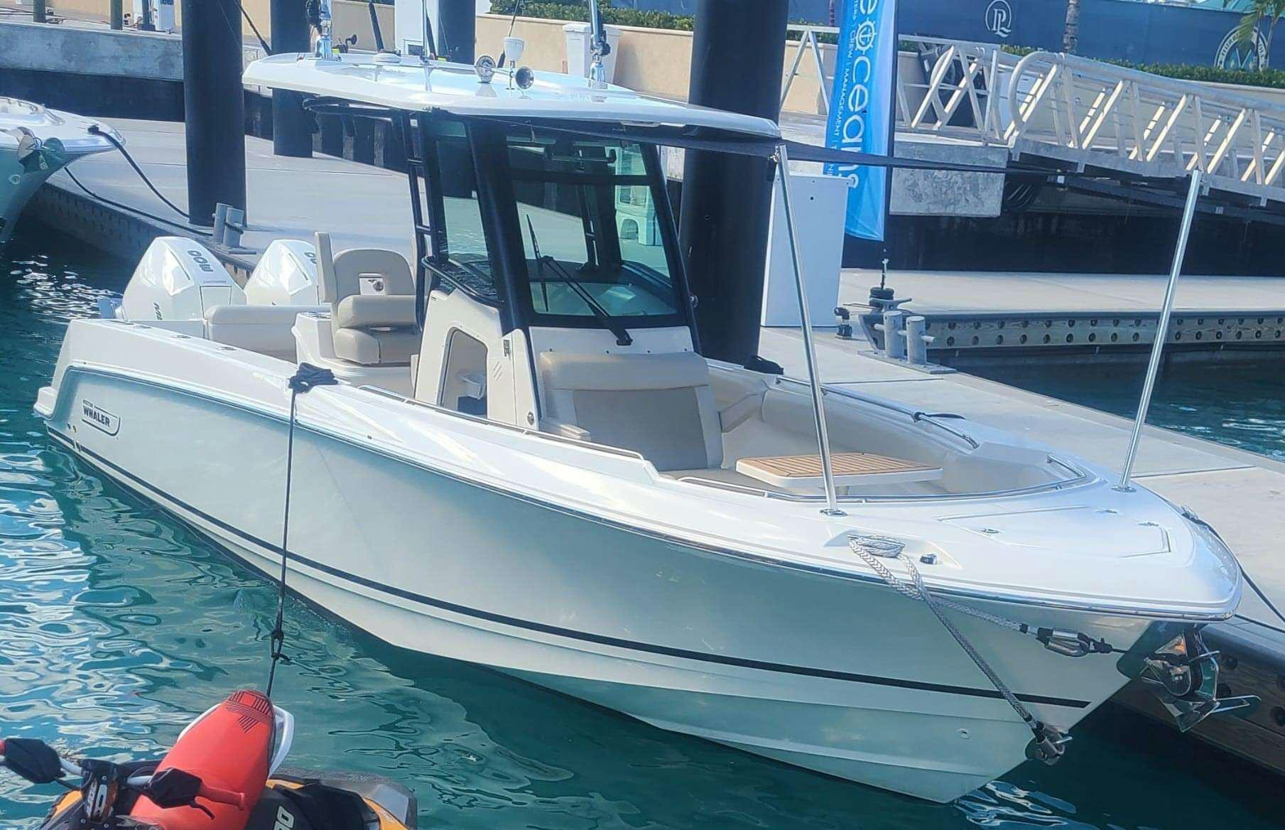 a white boat in a harbor aboard THE PEDDLER Yacht for Charter