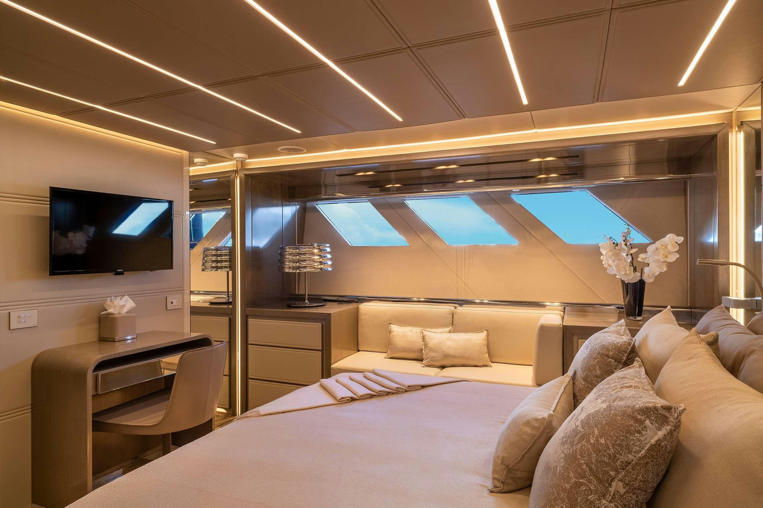 a room with a bed and a television aboard THE PEDDLER Yacht for Charter