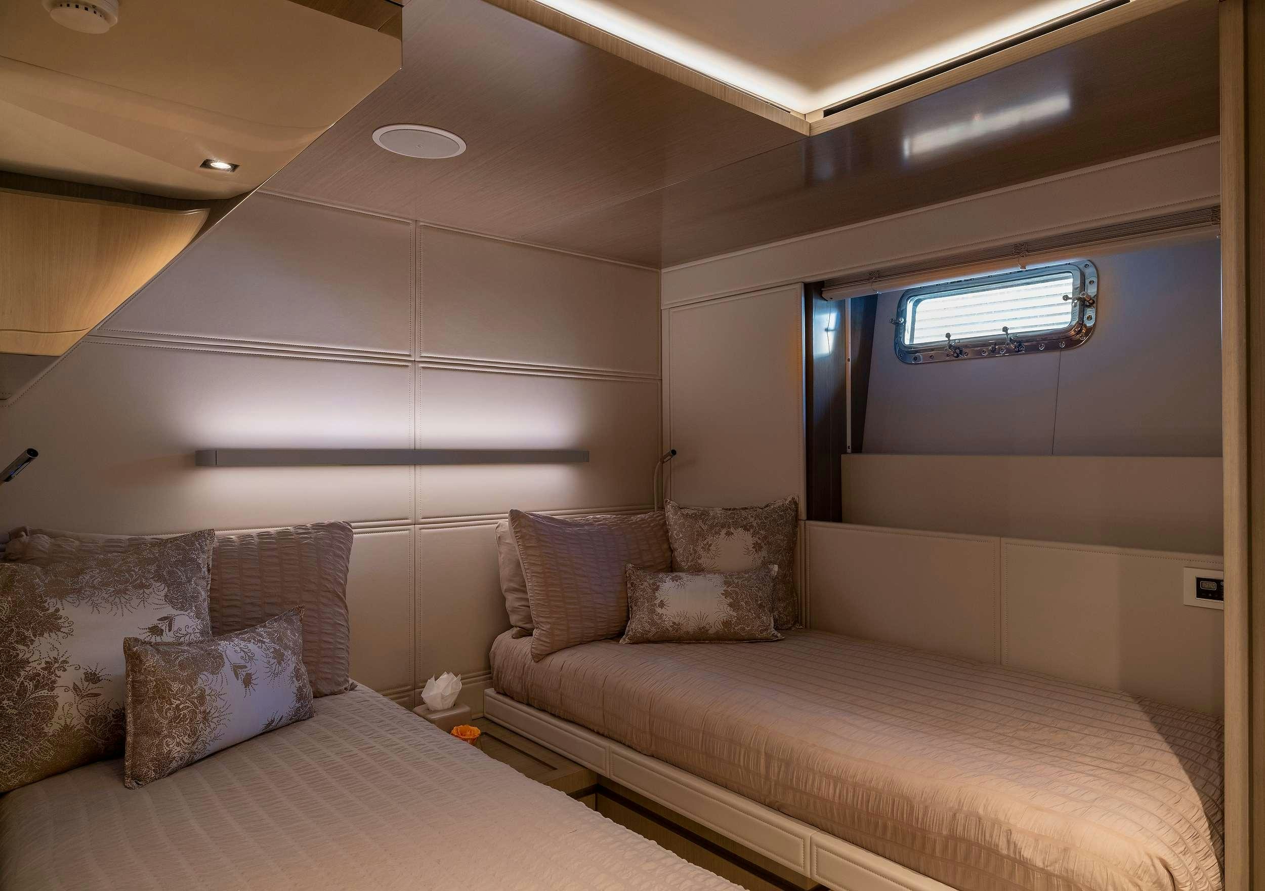 a room with a bed and a window aboard THE PEDDLER Yacht for Charter