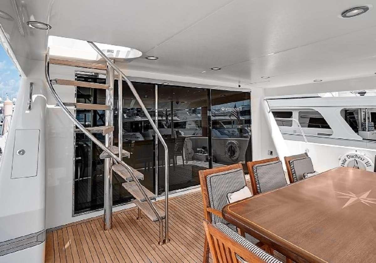 a room with a table and chairs aboard LADY B Yacht for Charter