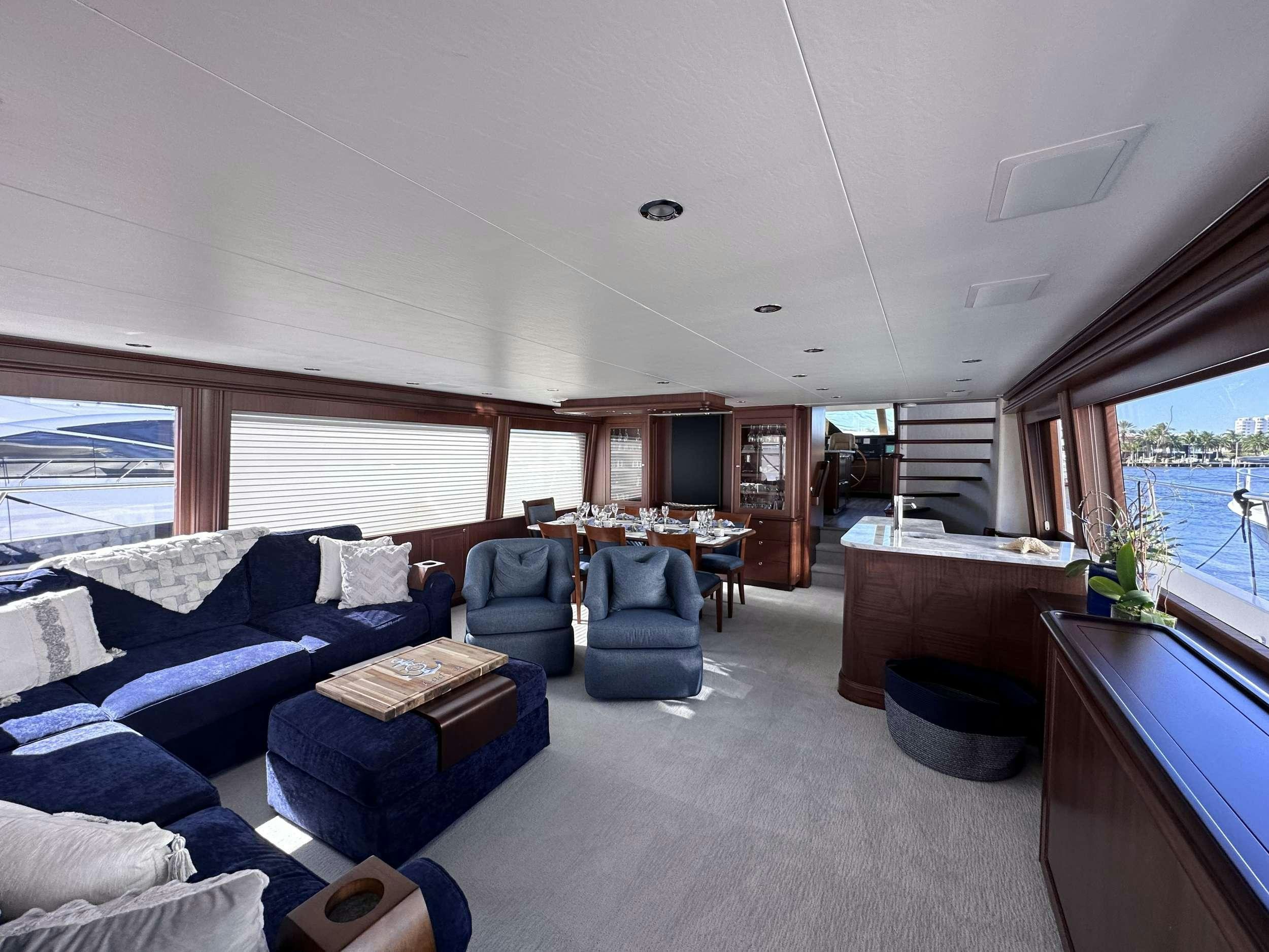 a living room with a large window aboard LADY B Yacht for Charter