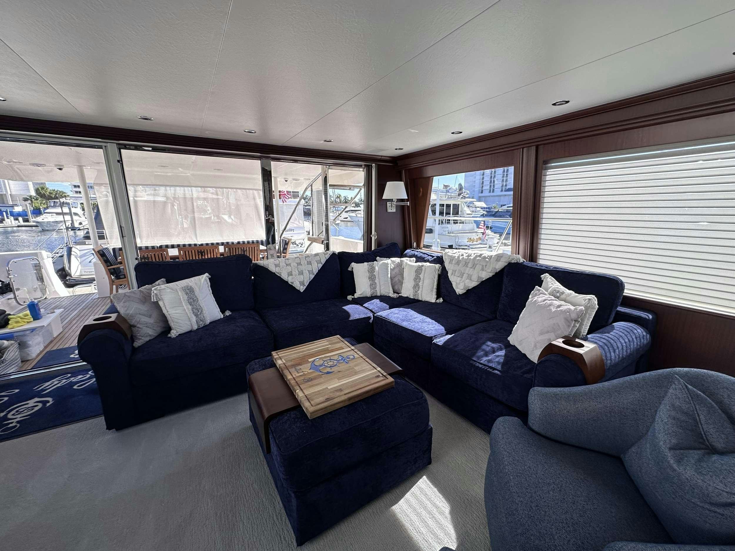 a living room with a large window aboard LADY B Yacht for Charter