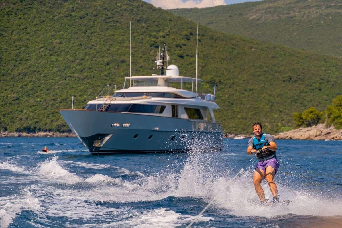 a man water skiing behind a boat aboard VALENTINA II Yacht for Charter