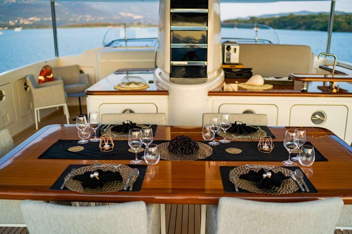 a table with food and wine glasses aboard VALENTINA II Yacht for Charter