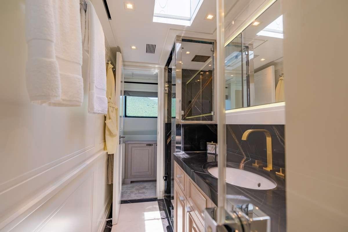 a bathroom with a sink and a mirror aboard VALENTINA II Yacht for Charter