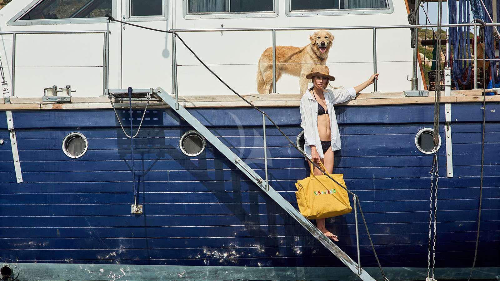 a person and a dog on a boat aboard ALMYRA Yacht for Charter