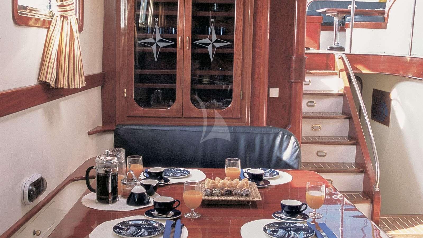 a kitchen with a table set with food and drinks aboard ALMYRA Yacht for Charter