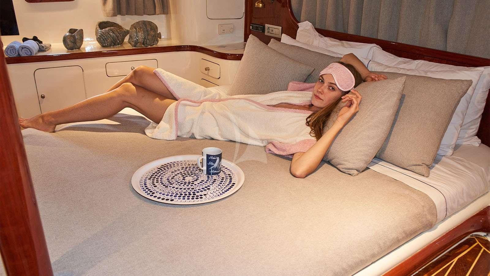 a person lying on a bed aboard ALMYRA Yacht for Charter