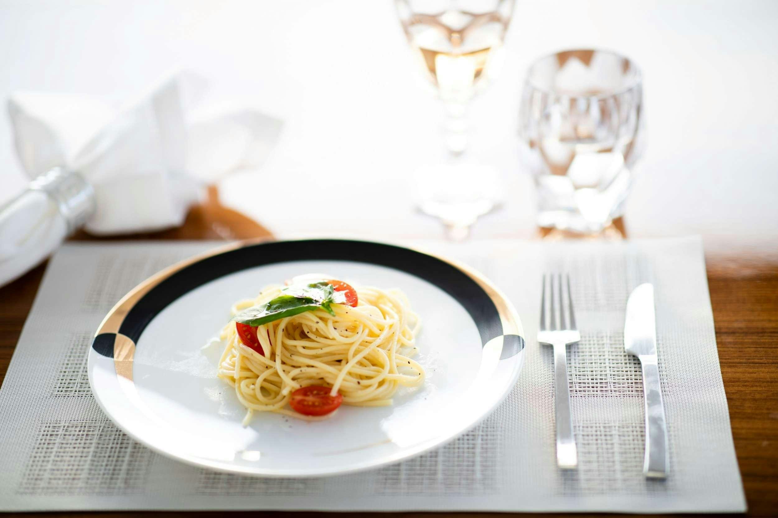 a plate of pasta and vegetables aboard SEAZEN II Yacht for Charter