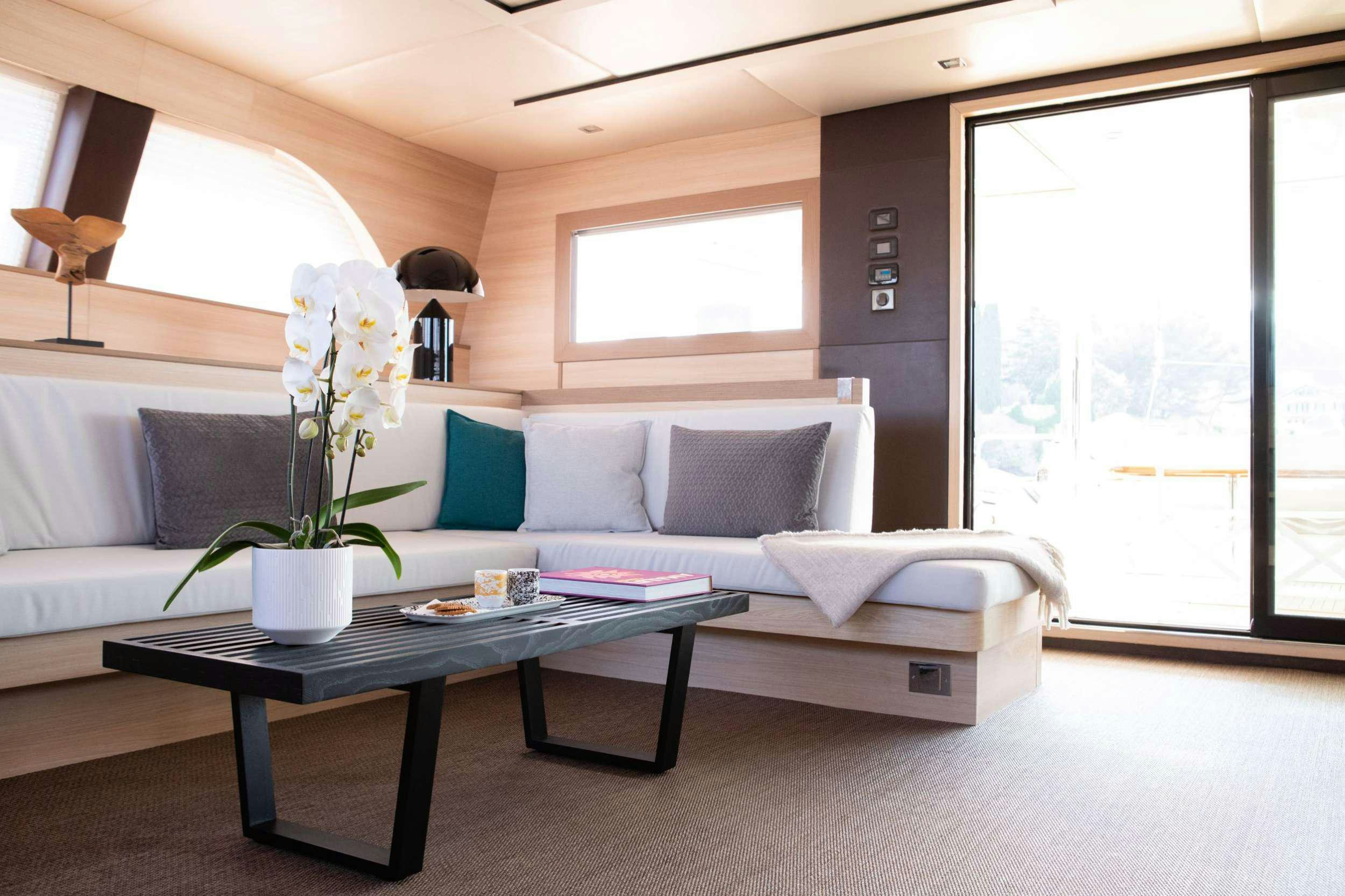 a living room with a white couch and a coffee table aboard SEAZEN II Yacht for Charter