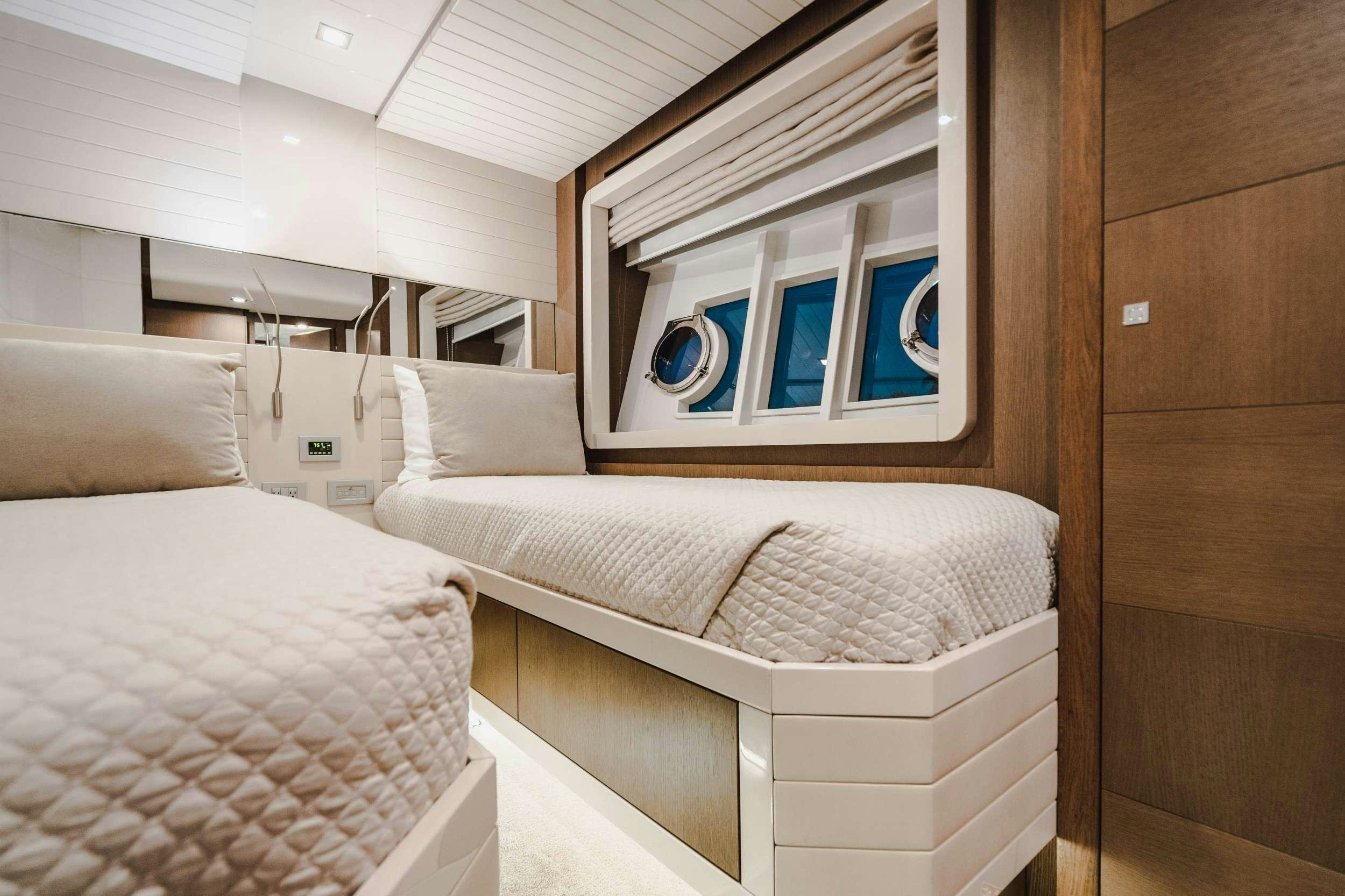 a room with two beds aboard MIRABILIS Yacht for Charter