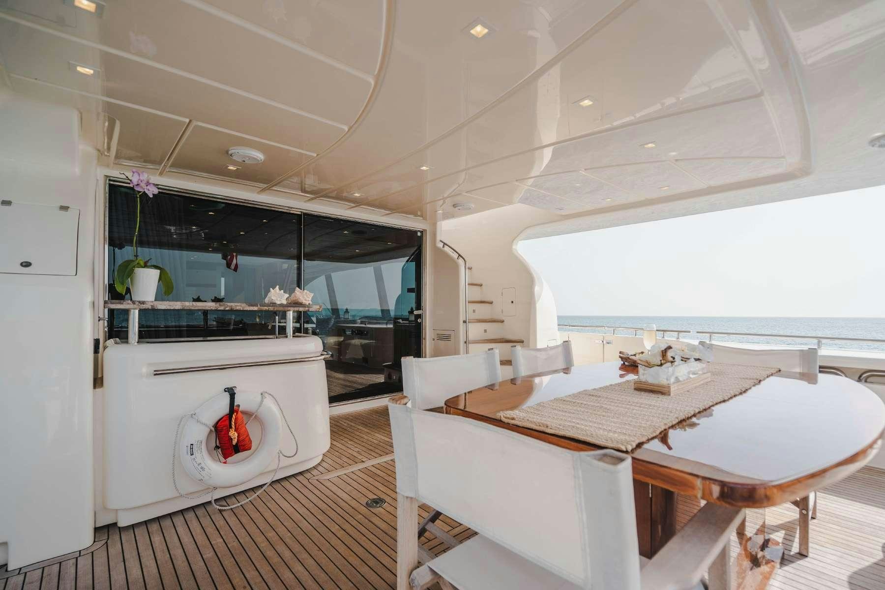 a room with a table and chairs aboard MIRABILIS Yacht for Charter