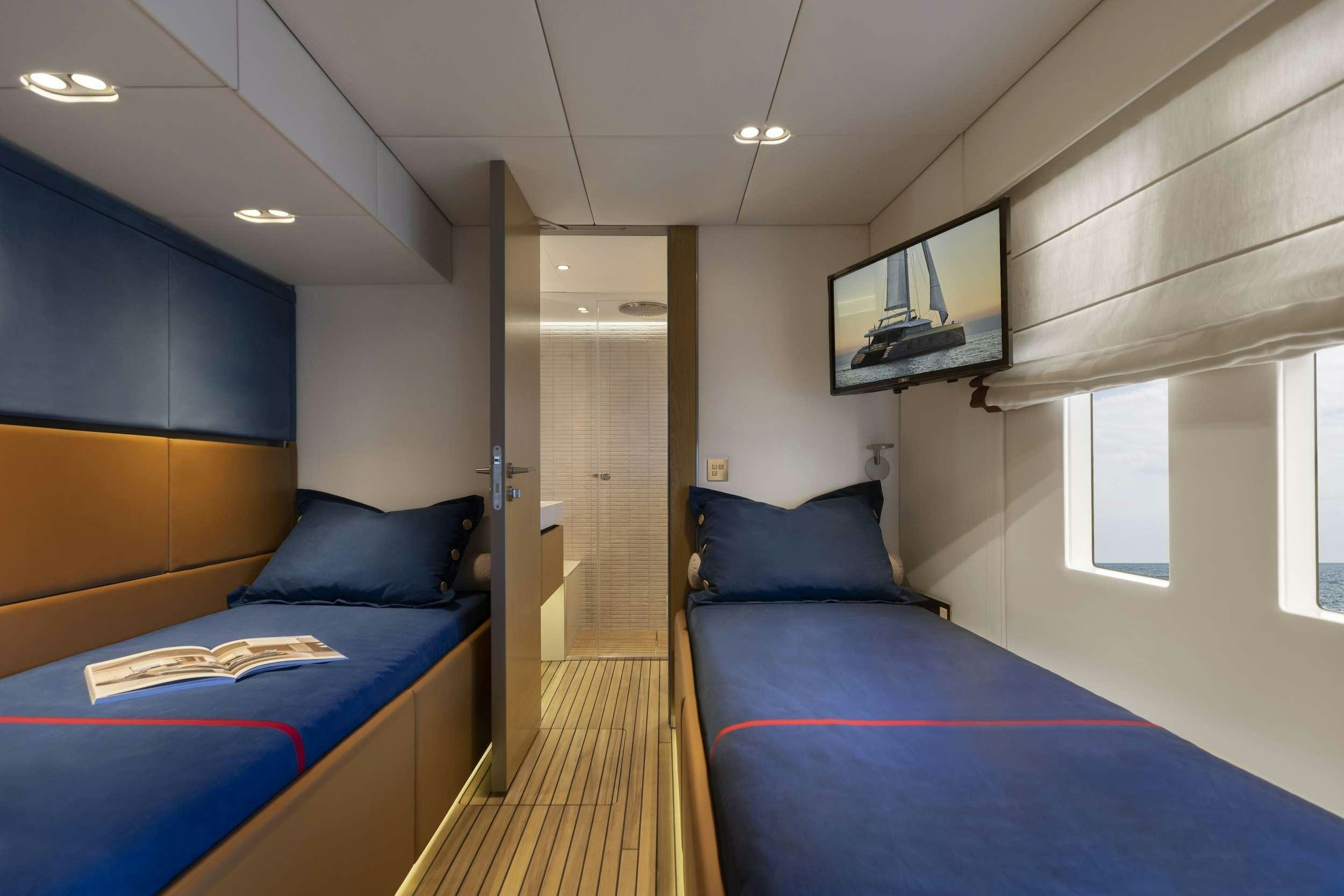a room with a bed and a blue bed aboard PRONTO Yacht for Charter