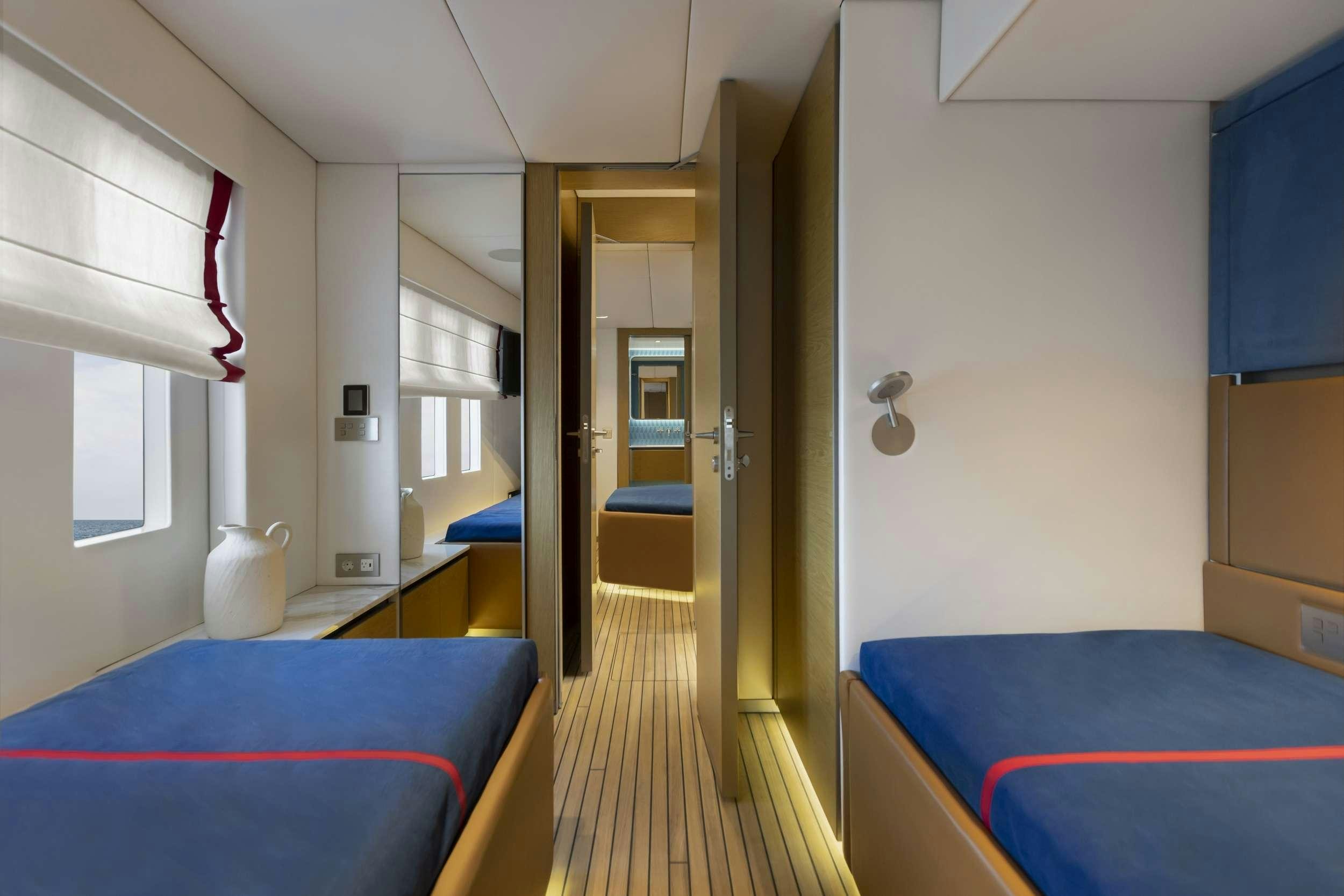 a room with a bed and a blue bed aboard PRONTO Yacht for Charter