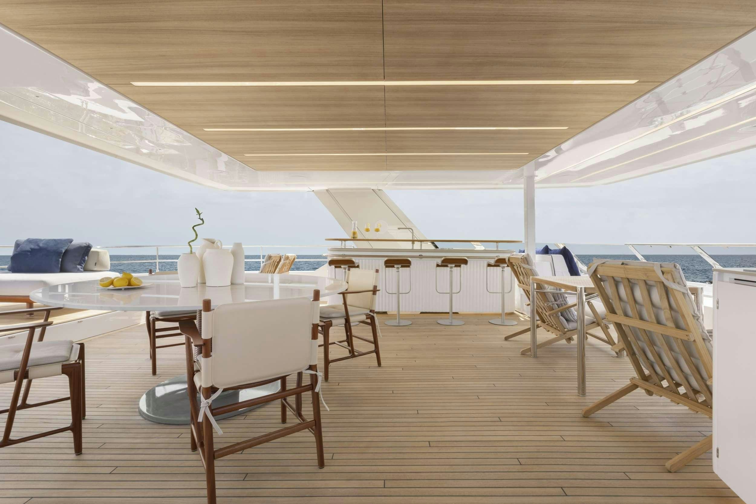 a room with tables and chairs aboard PRONTO Yacht for Charter