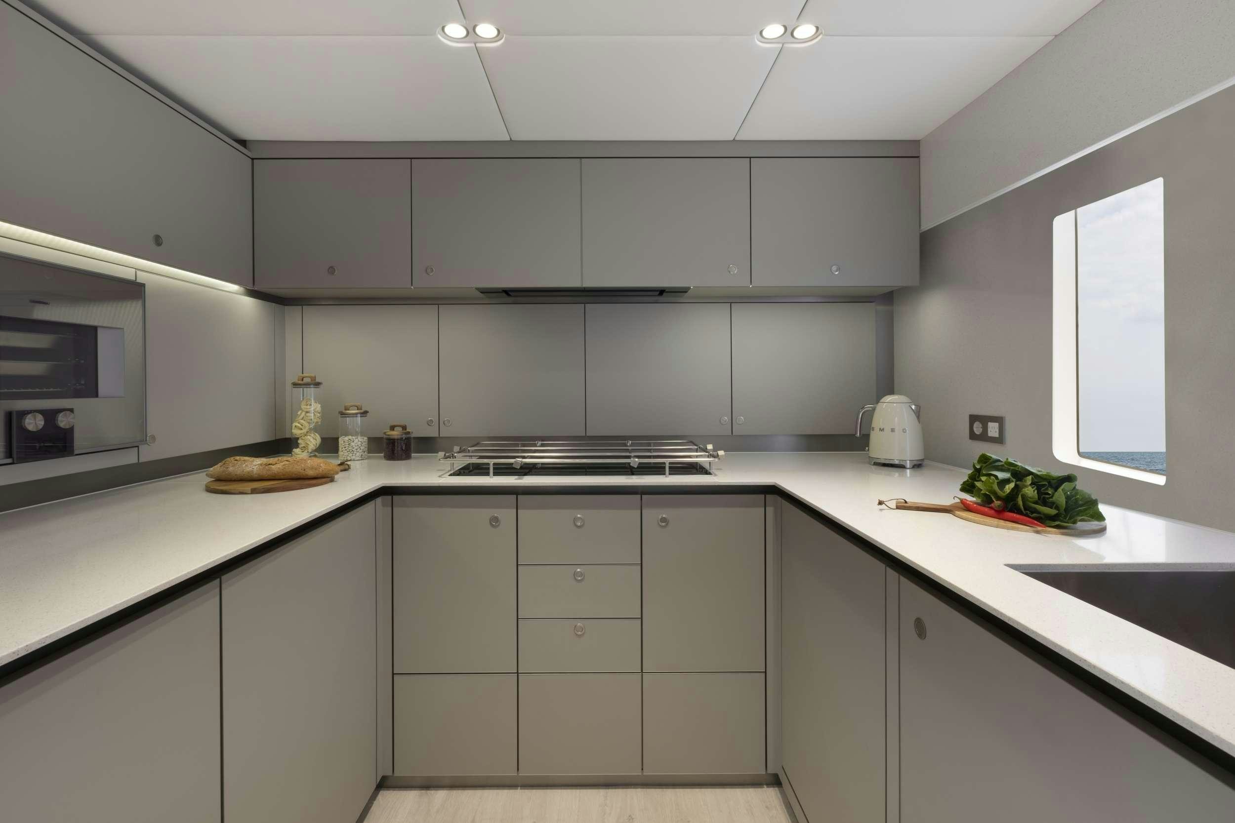 a kitchen with white cabinets aboard PRONTO Yacht for Charter