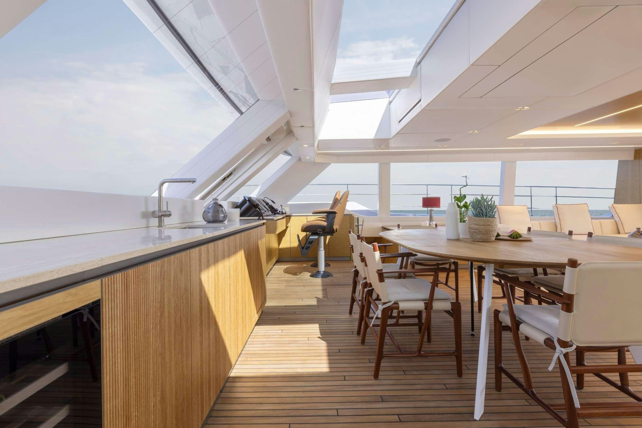 a kitchen with a table and chairs aboard PRONTO Yacht for Charter