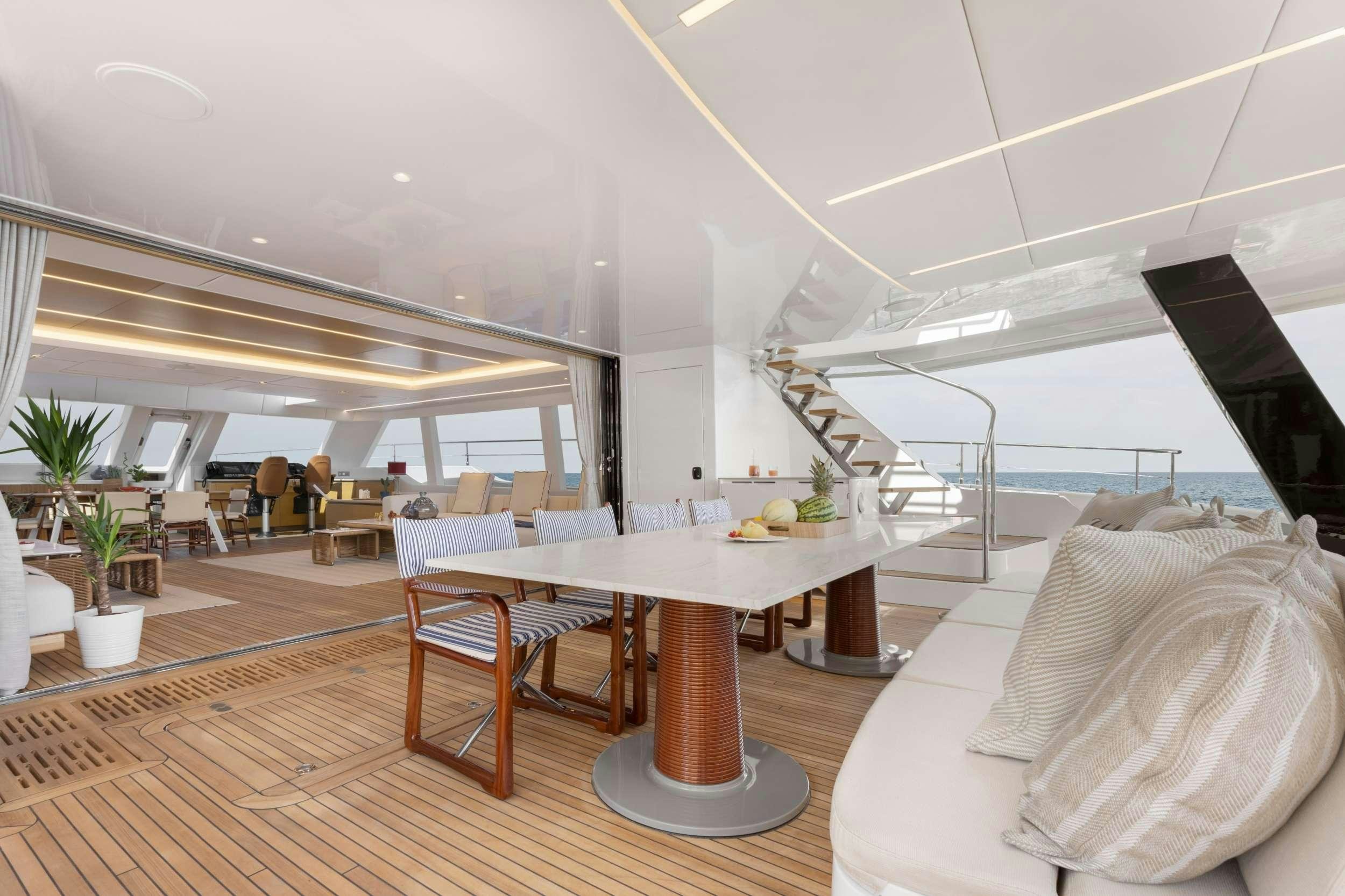 a room with a table and chairs aboard PRONTO Yacht for Charter