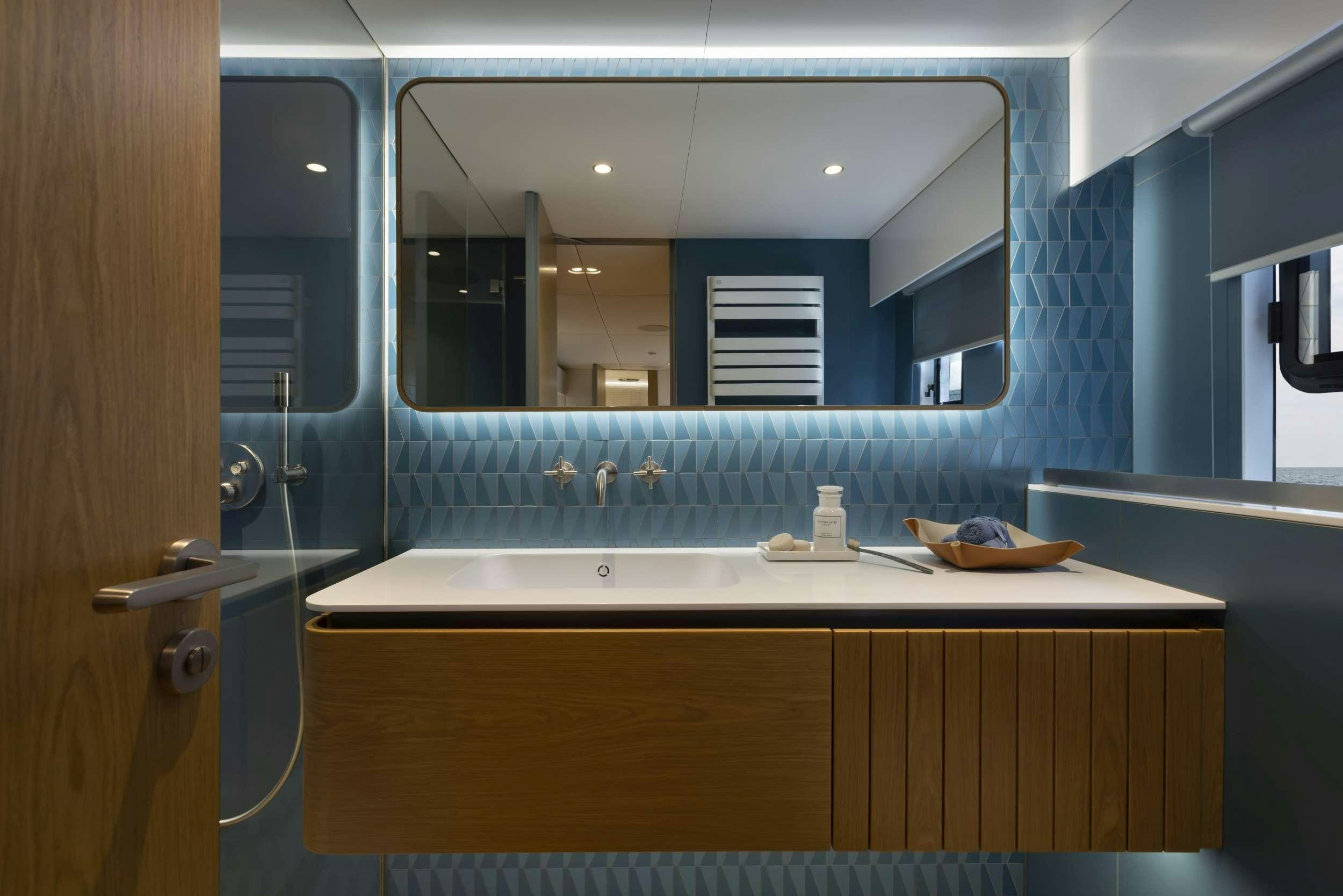 a bathroom with a large mirror aboard PRONTO Yacht for Charter